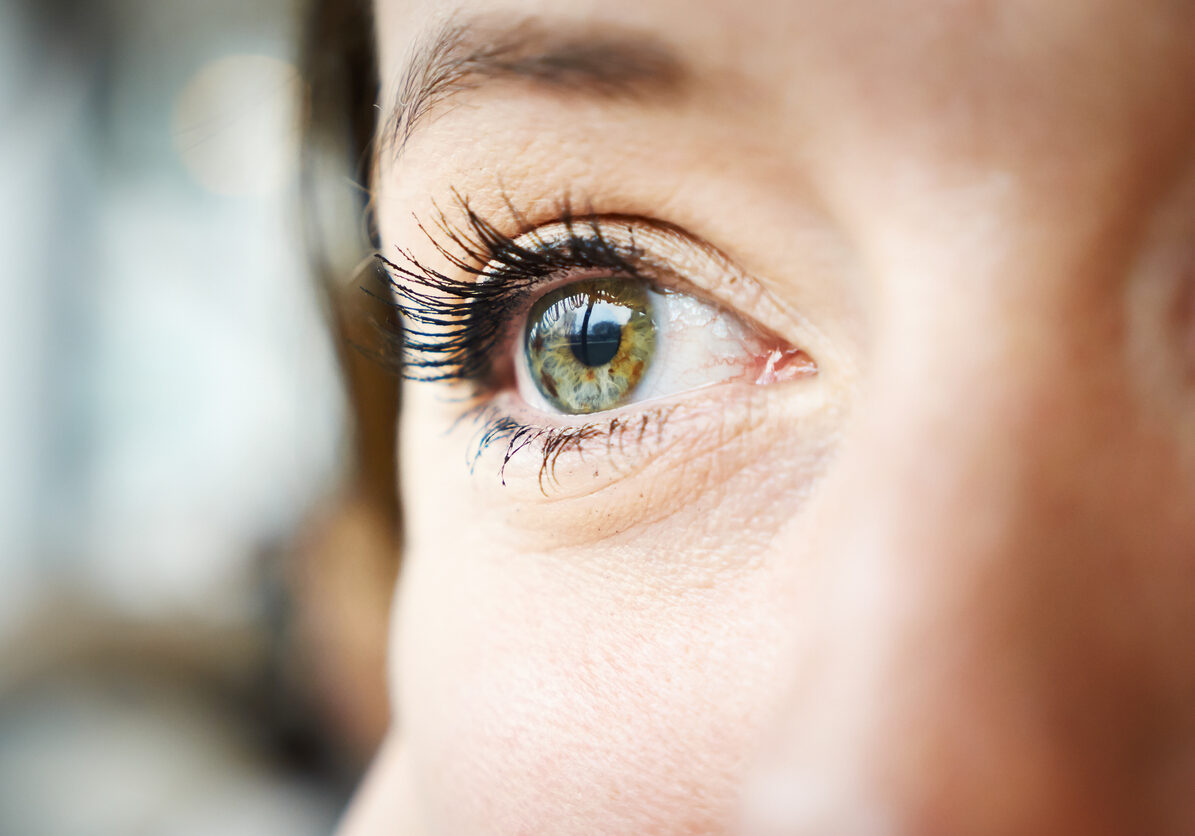 close up to a young woman's bright and green eyes. she is in love and dreams of her new boyfriend